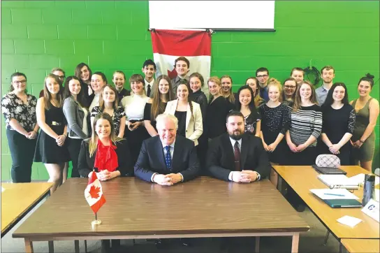  ?? MATTHEW MCCULLY ?? Former Premier of Quebec Jean Charest stopped by Alexander Galt Regional High school on Friday to talk to students involved in model parliament about his political career.
Seen here is Charest (centre) with Galt teachers Meagan Mckinven and Drew...