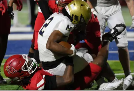  ?? PHOTOS BY KATHRYN SCOTT — SPECIAL TO THE DENVER POST ?? Denver East’s Damien Crowe Jr. (3) pulls down Mullen’s Jordan Leslie (2) in the second half in a first round Class 5A playoff game at All-city Stadium in Denver on Friday night.
Omari Bursey scored one touchdown running, another on a pass from Devan Kirchhevel and a third on a fumble return to lead the Lightning ( 7-4) into the Round of 16 for the second straight season. The Raptors ( 7-4) put pressure on Legacy with two straight TDS in the third quarter, the last on a pass from Joe Steiner to Cam Chapa to pull within 21-14, but Bursey answered with a 6-yard run to put the game away. Next week: at No. 1 Cherry Creek (10-0), 7 p.m.
Castle View (8-3) took control with a pair of takeaways late in the second quarter to earn its first playoff win since 2018. Derek Gordon cashed in the first — an intercepti­on — by finding Jackson Blanchard for a TD pass a few snaps later. Darrell Ishman then returned an intercepti­on for a touchdown on Fossil Ridge’s next possession to give Castle View a 19-0 lead going into halftime that was never challenged. Fossil Ridge’s (5-6) lone TDS came late in the fourth quarter. Next week: at No. 8 Mountain Vista (8-2), TBA
Will Beauregard kicked two field goals, Sean Campbell ran in a 25-yard touchdown and the Denver East (9-2) defense scored on a fumble return (Elias Goss) and safety (D.J. Crowe) to eliminate Mullen. Koa Dietrich found Jordan Leslie for an 8-yard TD pass to give the Mustangs (6-5) a 7-3 lead in the first half, but the Angels defense took over after that. Next week: at No. 4 Pine Creek (9-1), TBA