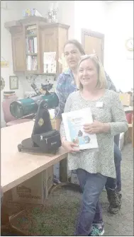  ?? Submitted photo ?? Katherine Auld of Supporting STEM & Space, Inc. presents the Bella Vista Public Library with a telescope which will be available for check-out to patrons in the coming weeks.