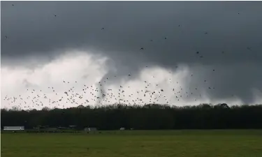  ?? The Associated Press ?? A tornado touches down Wednesday near Moundville in Hale County, Ala., causing damage to homes and downing trees.