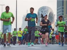  ?? Ahmed Ramzan/Gulf News ?? Flashing mobile lights, clapping and cheering, participan­ts of all ages joined the Run, with some families carrying toddlers.