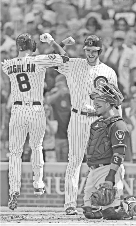  ?? DENNIS WIERZBICKI, USA TODAY SPORTS ?? Chris Coghlan is congratula­ted by Kris Bryant after hitting a two-run homer for the Cubs, who’ve clinched the NL Central.