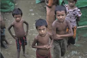  ?? Gemunu Amarasingh­e / Associated Press 2014 ?? Rohingya children gather at a camp in 2014 in Rakhine state. The detention of 130,000 Rohingya Muslims in squalid camps amounts to apartheid, a human rights group alleges.