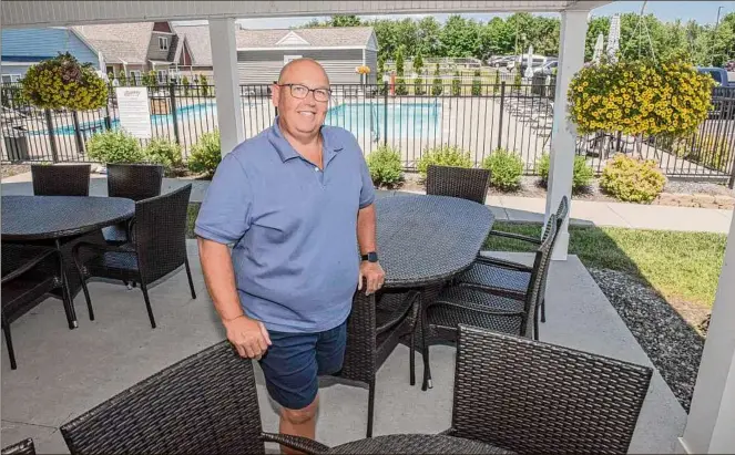  ?? Photos by Lori Van Buren / Times Union ?? Chet Fiske stands in the
community patio near the
pool at the clubhouse at
The Spinney at Pond View
in Castleton-on
-Hudson. Fiske and his
wife are retired and downsized their home.