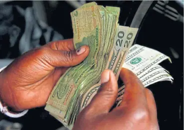  ?? /Reuters ?? Currency of note: An illegal money changer counts dollars in Harare, Zimbabwe, earlier in 2019. The Zimbabwean dollar was abolished in favour of the US currency in 2009, which eliminated runaway inflation until bond notes were introduced.