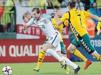  ?? ASSOCIATED PRESS FILE PHOTO ?? England’s Harry Kane, left, challenges Lithuania’s Arturas Zulpa, right, and Fiodor Cernych during their World Cup Group F qualifying soccer match last October.