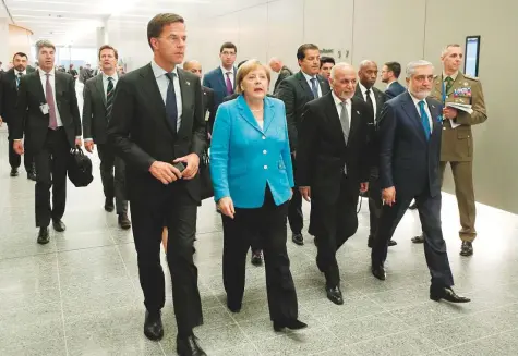  ?? AP ?? Netherland­s’ Prime Minister Mark Rutte, Germany’s Chancellor Angela Merkel, Afghanista­n’s President Ashraf Gani and Afghan Chief Executive Abdullah Abdullah walk between meetings on the second day of the Nato summit in Brussels yesterday.