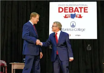  ?? PAUL VERNON / POOL / VIA THE NEW YORK TIMES ?? Democrat Richard Cordray (left) shakes hands with Republican Mike DeWine before their debate Oct. 1 at Marietta College in their campaign to be Ohio’s next governor. The two men have advanced a number of policies to deal with the state’s opioid addiction crisis.