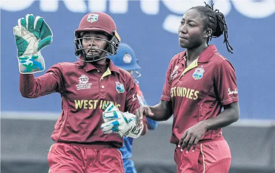  ??  ?? West Indies’ Stafanie Taylor, right, celebrates with Shemaine Campbelle after taking a wicket against Thailand.