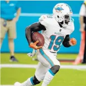  ?? WILFREDO LEE/AP ?? Dolphins wide receiver Jakeem Grant returned a kickoff 102 yards for a touchdown against Tennessee on Sunday.