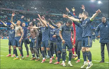  ?? ?? Real Madrid players celebrate victory in front of their fans at the Etihad Stadium on Wednesday.