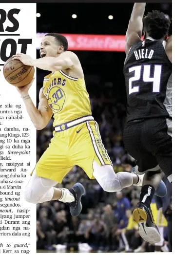  ?? / AP ?? ■ ASA KA? Ang pambato sa Golden State Warriors nga si Stephen Curry, wala, nga nakaipsot sa depensa ni Buddy Heild (24) sa Sacramento Kings ning aktoha atol sa ialng duwa kagahapon sa NBA.