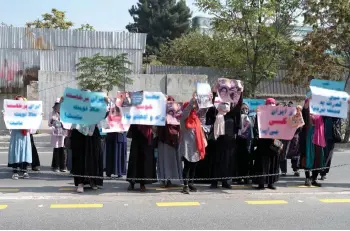  ?? — AFP photo ?? Afghan women hold placards as they take part in a protest in front of the Iranian embassy in Kabul.