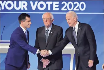  ?? aP-Charles krupa ?? From left, Democratic presidenti­al candidates former South Bend Mayor Pete Buttigieg, shakes hands with former Vice President Joe Biden as Sen. Bernie Sanders, I-Vt., watches Friday, Feb. 7, before the start of a Democratic presidenti­al primary debate hosted by ABC News, Apple News, and WMUR-TV at Saint Anselm College in Manchester, N.H.