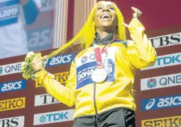  ?? GLADSTONE TAYLOR/MULTIMEDIA PHOTO EDITOR ?? World 100m champion Shelly-Ann Fraser-Pryce beams during yesterday’s medal ceremony after becoming the first woman to hold four such titles with an impressive win at the 2019 IAAF World Athletics Championsh­ips in Doha, Qatar, on Sunday.