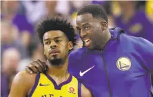  ?? Marcio Jose Sanchez / Associated Press ?? Warriors forward Draymond Green counsels Quinn Cook during a late-season game against the Bucks.