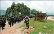  ?? (AP/Chris Mamu) ?? Ugandan soldiers, who had been fighting Ugandan rebels in Congo for the previous three years, cross the Mpondwe border point as they return to their home country in October 2001.