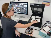  ?? Phototroni­cs via AP ?? In this July 18, 2017 photo, imagining specialist Erin McClintic works in the lab at Phototroni­cs in Winnetka, Ill., digitizing and archiving a shoebox of customer photograph­s, right.