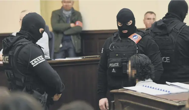  ?? PICTURE: EMMANUEL DUNAND ?? 0 Flanked by masked and armed police guards, Salah Abdeslam sits in a Brussels courtroom, where he refused to stand or answer questions