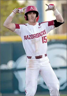  ?? NWA Democrat-Gazette/ANDY SHUPE ?? Arkansas freshman Casey Martin gestures to the Razorbacks’ dugout after driving in a run with a double in the third inning of Thursday night’s game against South Carolina at Baum Stadium in Fayettevil­le.