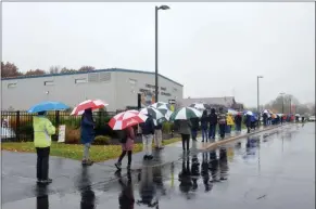  ?? LAUREN HALLIGAN - MEDIANEWS GROUP ?? Voterswait in line on a rainy day to cast their ballots early at Gavin Park inWilton, one of three early voting sites in Saratoga County.