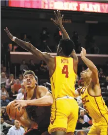  ?? Jae C. Hong / Associated Press ?? Reid Travis (left), whose 16 points led Stanford, looks to shoot under pressure by USC’s Chimezie Metu and Derryck Thornton.