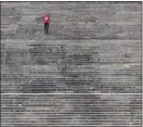  ?? MATT ROURKE - ASSOCIATED PRESS ?? A person exercises on the typically more frequented steps of the Philadelph­ia Museum of Art in Philadelph­ia, Friday, April 3. The museum has temporaril­y closed due to the COVID-19pandemic.