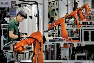  ?? AP/VINCENT YU ?? A computer factory in Shenzhen, China, was a hive of activity in 2015. U.S. exports to China have dropped 15% in the first nine months of this year as trade talks have dragged on.