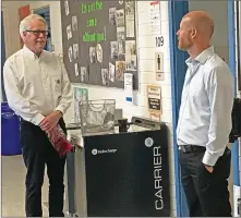  ?? Images ?? Former principal Jim Asplund, left, visits with Huntsville School Principal Chris Spanos during a farewell tour of the building.