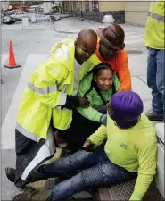  ?? SCOTT THRELKELD/THE ADVOCATE VIA AP ?? Workers are helped after a large portion of a hotel under constructi­on suddenly collapsed in New Orleans on Saturday. Several constructi­on workers had to run to safety as the Hard Rock Hotel, which has been under constructi­on for the last several months, came crashing down. It was not immediatel­y clear what caused the collapse.