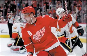  ?? AP PHOTO CARLOS OSORIO ?? Detroit Red Wings left wing Justin Abdelkader (8) reacts after his goal during the second period of an NHL hockey game against the Calgary Flames, Wednesday in Detroit.