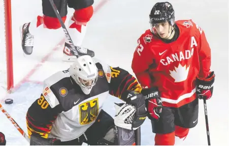  ?? CODIE MCLACHLAN/ GETTY IMAGES ?? Dylan Cozens, right, has been a pain in the side of opposing goalies, such as Germany's Jonas Gahr.