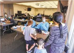  ?? EDUARDO CONTRERAS U-T ?? Priscilla Waldron (middle facing camera) talks about the COVID test at the Chula Vista Elementary School District Education Service and Support Center.