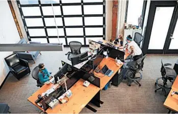  ?? LEAH NASH/THE NEW YORK TIMES ?? Lilly, left, and Dylan Taylor attend remote school Sept. 8 at their mother’s empty office at Kinesis in Portland, Oregon.