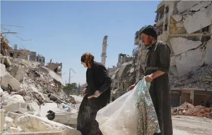  ??  ?? ALEPPO’S SALAHUDDIN neighborho­od was divided between opposition and government forces until rebels left in December. Now, many former residents are coming back to see what became of their homes. Others come to pick through the rubble.