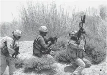  ?? ETHAN BARON/POSTMEDIA NEWS ?? Canadian soldiers respond to incoming fire in Helmand Province, Afghanista­n in 2006. Canadian troops are again seeing action in a far-off land and the mental-health issue that emerge.