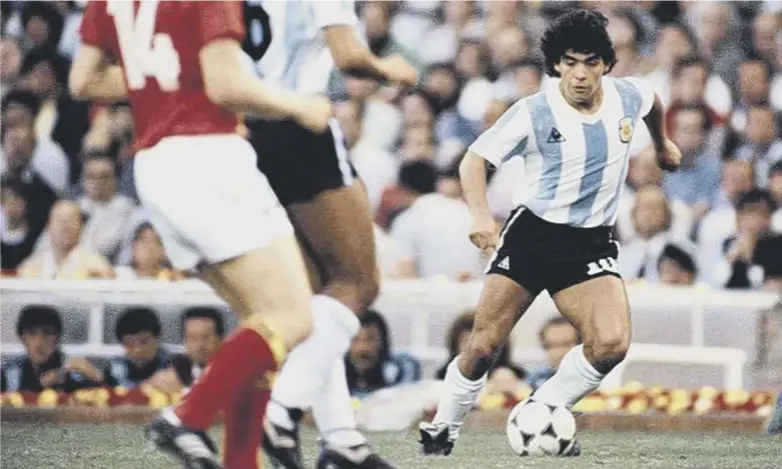  ??  ?? 0 Diego Maradona, who died of a heart- attack earlier this week, takes on the Belgium defence at the Nou Camp during the 1982 World Cup finals. For many football supporters, especially those now around 50