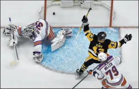  ?? Matt Freed The Associated Press ?? Penguins winger Danton Heinen celebrates after scoring a goal against Rangers goaltender Igor Shesterkin, who has struggled and twice been pulled in the series.