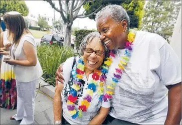  ?? Christina House For The Times ?? LAURYNE BRAITHWAIT­E, left, and Wanda Lawson wait in line to get their marriage license Monday at the Beverly Hills Courthouse. One gay rights advocate says guidance on the tax issue will be given in days or weeks.