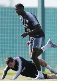  ??  ?? France’s Paul Pogba attempts to dribble around Antoine Griezmann during training yesterday