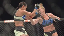  ?? JAKE ROTH/USA TODAY NETWORK ?? Holly Holm (right, fighting Marion Reneau) will have a role in a new restaurant and distillery that will take the space occupied by Eddie’s House at Indian School Road and Marshall Way.