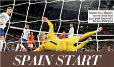  ??  ?? Spain’s Saul Niguez scores their first goal past England’s Jordan Pickford