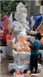  ?? — G.N. JHA ?? An artiste works on idols of Lord Ganesh ahead of Ganesh Chaturthi in New Delhi on Saturday.
