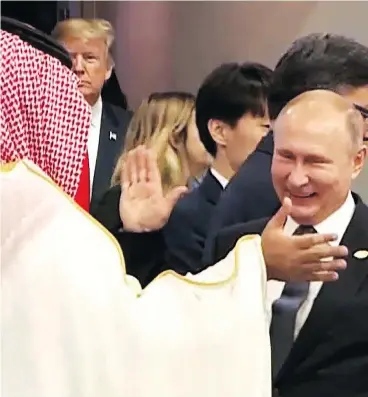  ?? AFP PHOTO /G20 ARGENTINA ?? Russia’s President Vladimir Putin and Saudi Arabia’s Crown Prince Mohammed bin Salman greet each other warmly at the G20 Leaders’ Summit in Buenos Aires, on Friday, as U.S. President Donald Trump enters the room.
