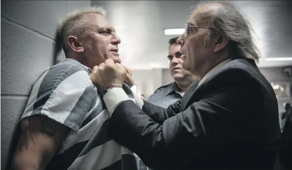  ?? PHOTOS: EONE FILMS ?? Daniel Craig, left, gets roughed up by Dwight Yoakam in Logan Lucky. Craig, sporting bleach-blond hair, plays a munitions expert who goes by the name Joe Bang.