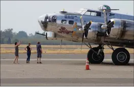  ?? PHOTOS BY STEVE SCHOONOVER/ENTERPRISE-RECORD ?? ABOVE and BELOW: Visitors at the Chico Airport Thursday take pictures of a WWII-era B-17 bomber named Sentimenta­l Journey. The plane will be at the Chico Air Museum for ground tours and flights starting Friday in Chico.