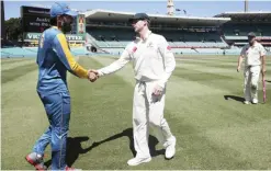  ??  ?? SYDNEY: Australia’s captain Steven Smith, center, shakes hands with his counterpar­t Pakistan’s Misbah-ul-Haq after Australia defeated Pakistan in their cricket Test match in Sydney. —AP