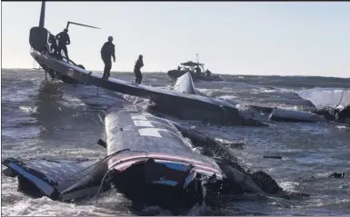  ?? GUILAIN GRENIER/ ORACLE TEAM USAVIA ASSOCIATED PRESS ?? Oct 16: The AC72 yacht breaks up after capsizing in the bay, stoking criticism of the controvers­ial design
The crew of the capsized Oracle AC72 is rescued after the yacht’s hulk was swept past the Golden Gate Bridge.