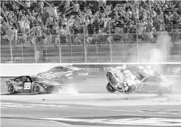  ?? MATT KELLEY/AP ?? Chris Buescher (17) and Daniel Suarez (99) crash during Sunday night’s Coca-Cola 600 at Charlotte Motor Speedway. Buescher’s Ford flipped five times, but he was OK.