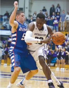  ?? | AP ?? Northweste­rn’s Scottie Lindsey drives around DePaul’s Chris Harrison- Docks during the second half Saturday at Welsh- Ryan Arena. Lindsey scored 19 points.